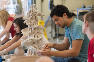 Student working on a large sculpture