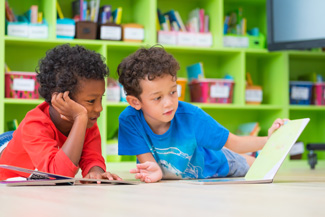 Two boys looking at a book