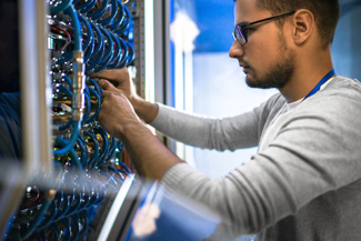 Computer technician rewiring server