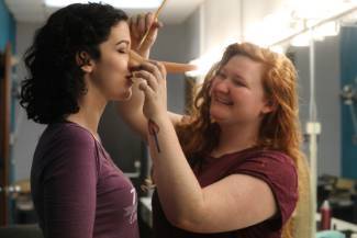 Students putting on makeup and props