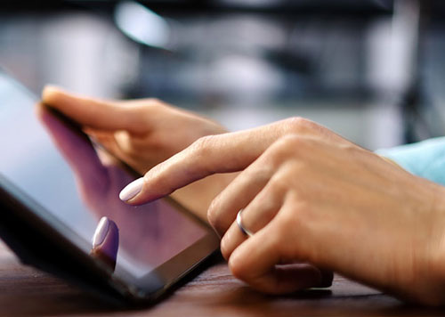 Person holding a tablet in their hand