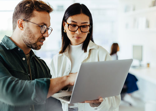 Man and Woman looking at a laptop together