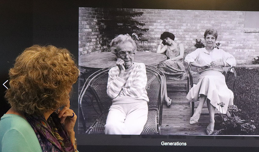 Debra explaining a picture of her, her mother and grandmother.