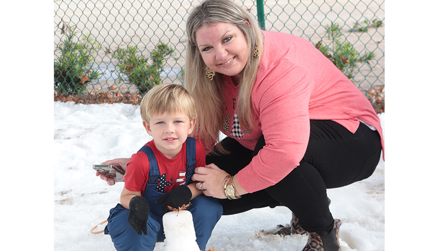 Mom and son making snow man