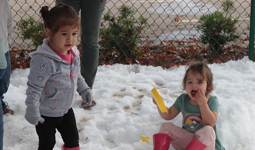 Two girls playing with the snow