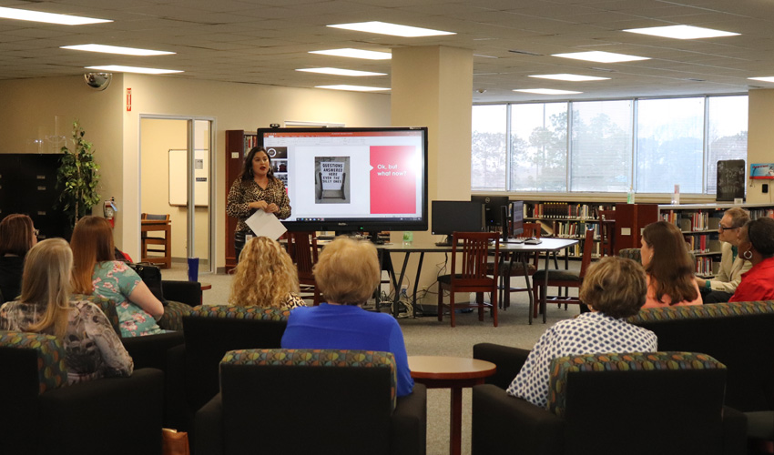 Liz Sitta talking to audience about defining public service