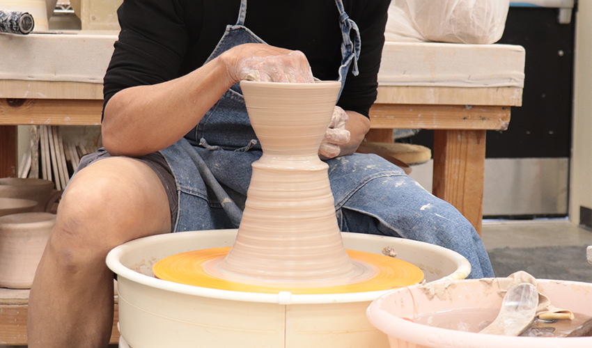 Mr. V. Chin making a ceramic bowl.