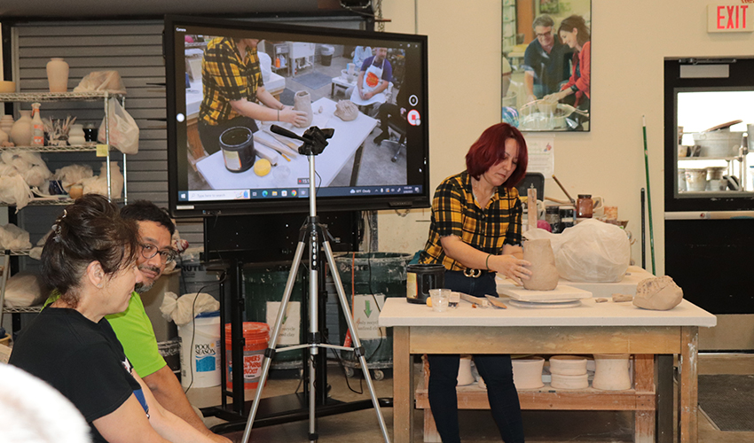 Mrs. Jeanee making a sculpture.