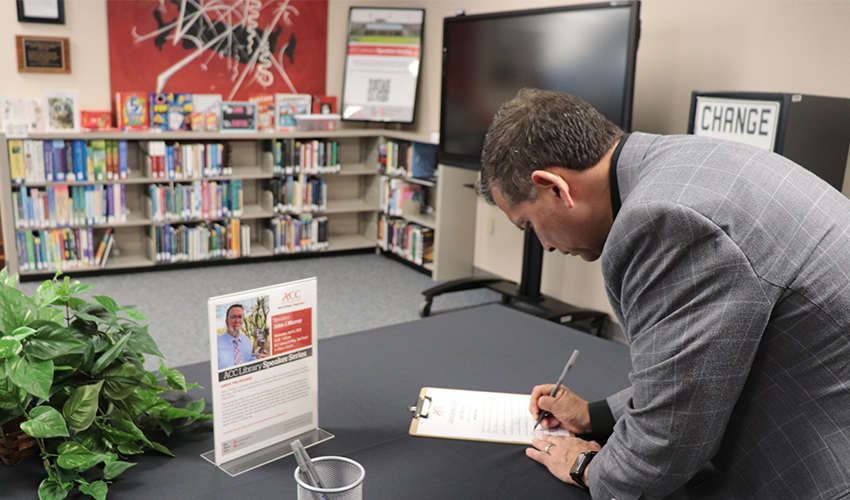 Audience signing in for John Murray's presentation