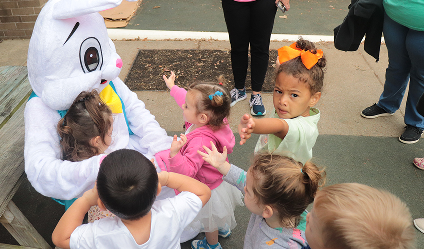 Kids getting ready to hug Mr. Bunny.