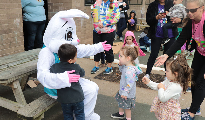 Kids getting ready to hug Mr. Bunny.