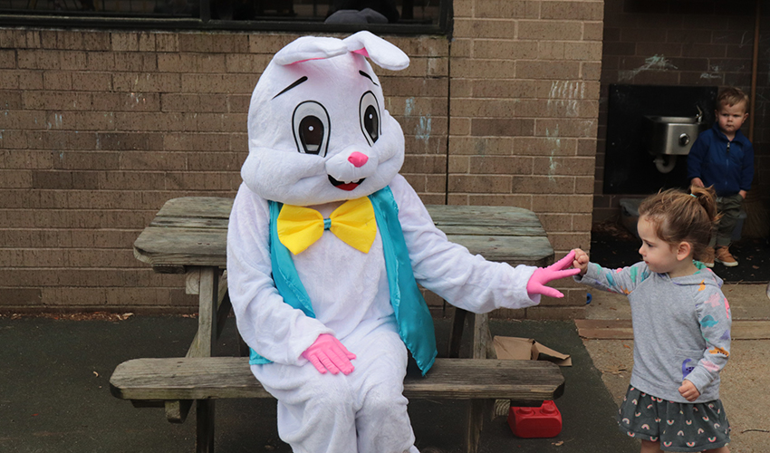 Mr. Bunny giving a girl a high five.