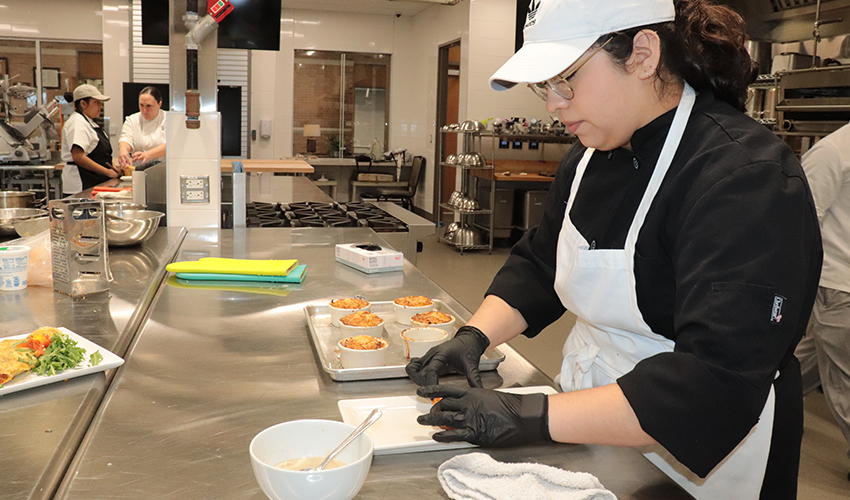 Culinary Arts student spends time plating her culinary dish.