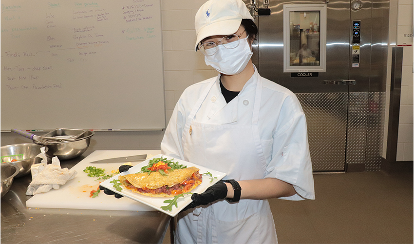 Culinary Arts student showing her culinary dish.