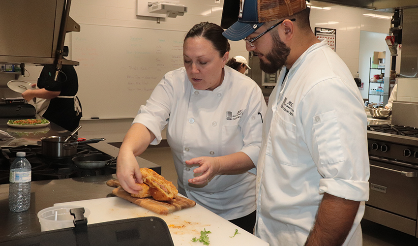 Chef Laura showing her student some plating techniques.