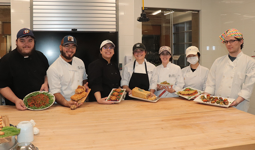 Picture of the Culinary Arts students showing their dishes.