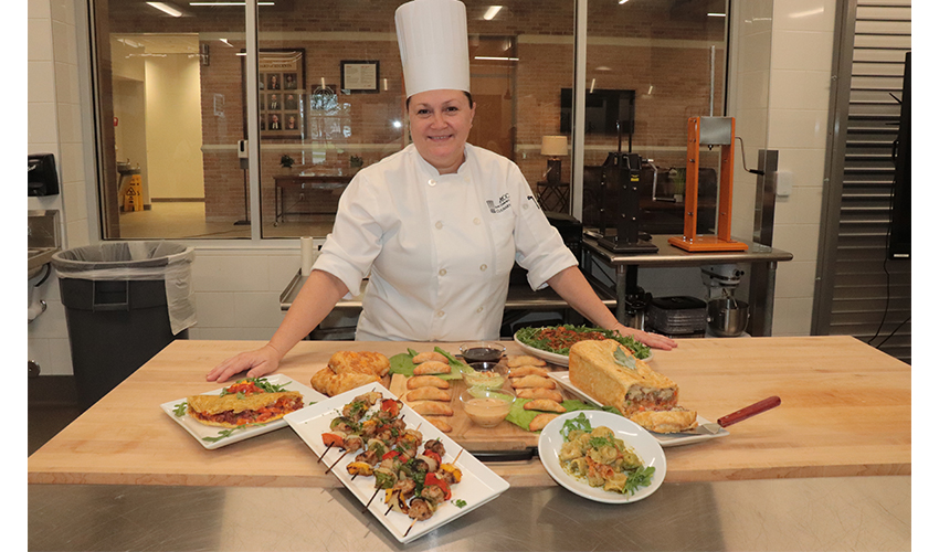 Picture of the Chef Laura standing behind the students dishes.