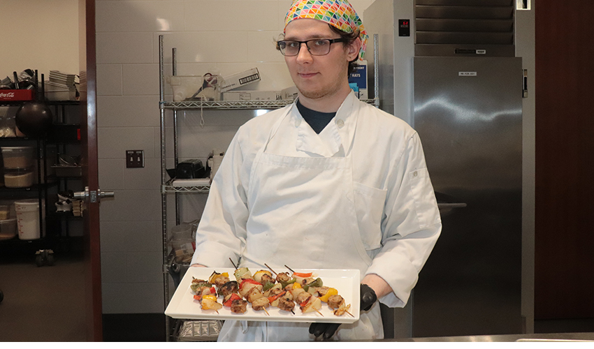 Culinary Arts student showing his culinary dish.