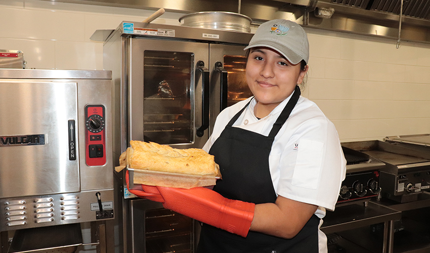 Culinary Arts student showing her culinary dish.