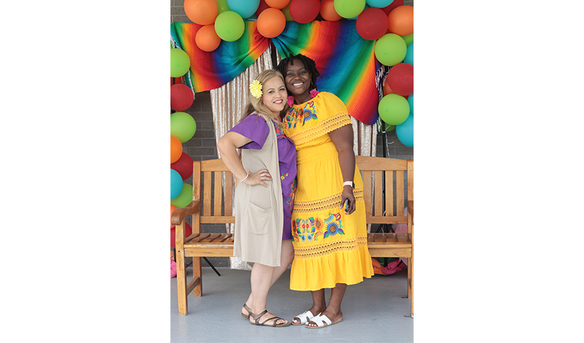 Coordinator of Students Activities and her assistant dressed up in traditional Mexican dress. 