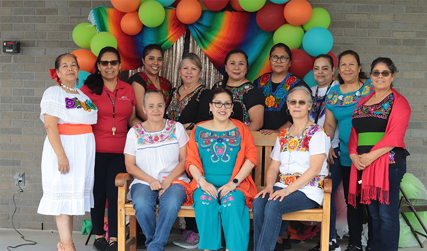 Custodian staff dressed in traditional Mexican colorful outfits. 
