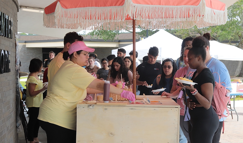 Students in line to get their traditional Mexican corn in a cup. 
