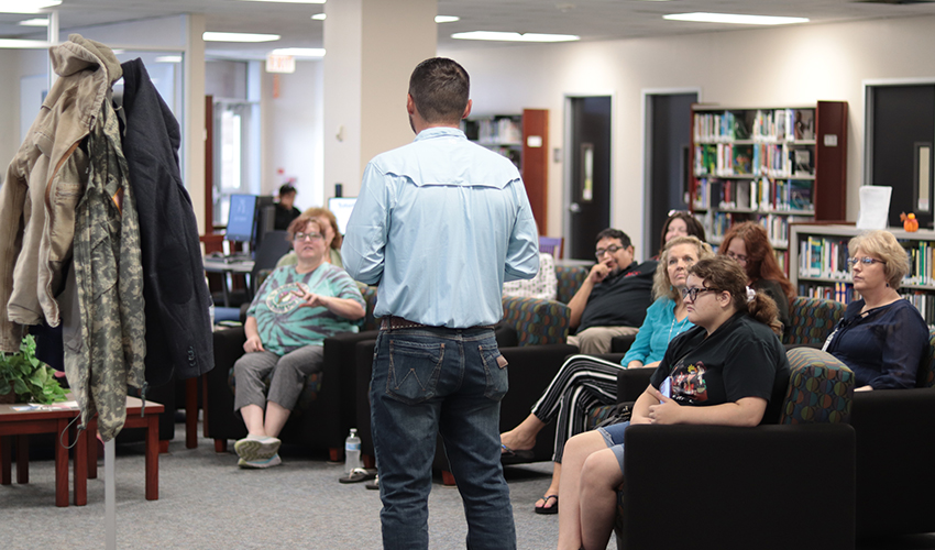 Tyler Froberg standing in front of the audience giving his presentation.