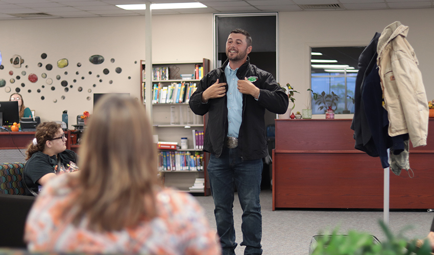 Tyler Froberg standing in front of the audience giving his presentation.