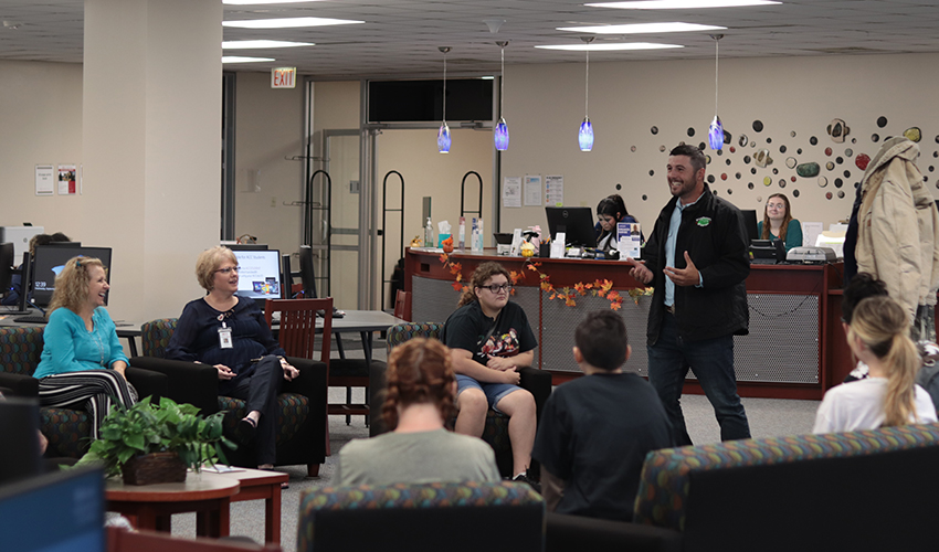 Tyler Froberg standing in front of the audience giving his presentation.