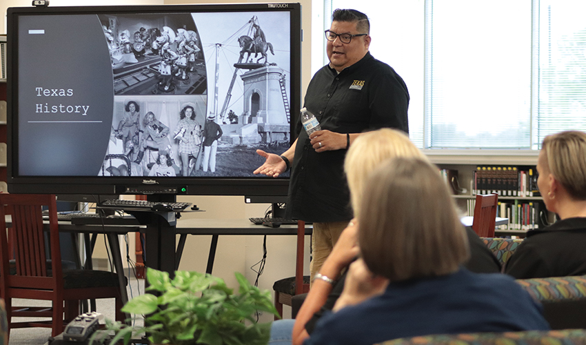 Joe Perez standing in front of the audience giving his presentation. 
