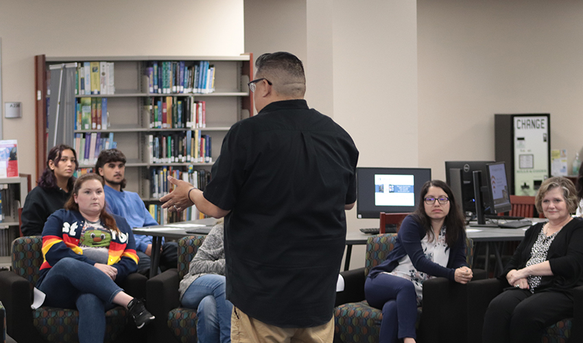 Joe Perez standing in front of the audience giving his presentation. 
