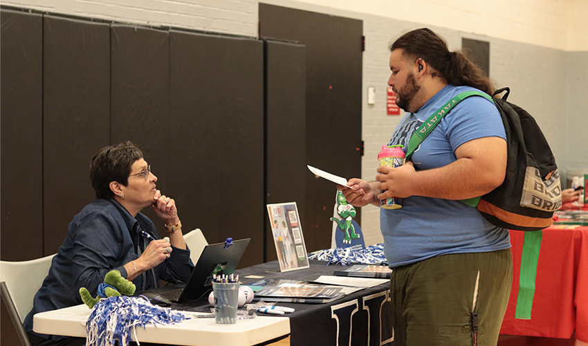 Student getting information at one of the Universities' booths.