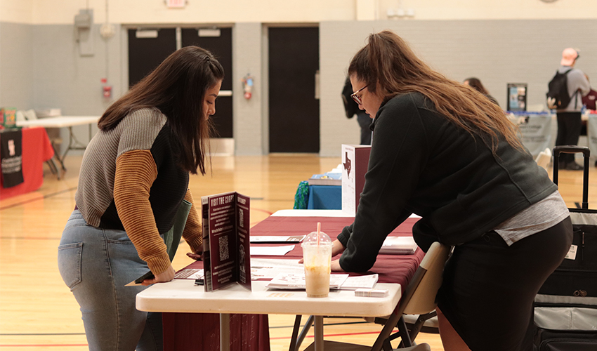 Student getting information at one of the Universities' booths.