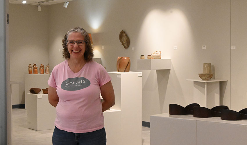 Karen Fiscus posing in front of her art.