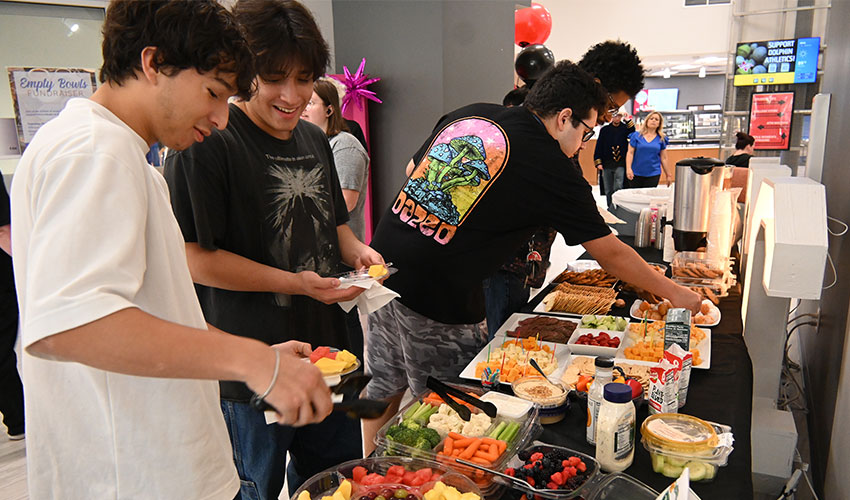 Students enjoying the snacks from the art exposition.