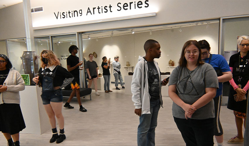 Students looking at the arts exposition of Karen Fiscus.