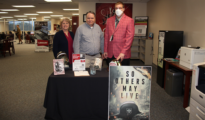 Picture of Brady Hutchison with the library staff.