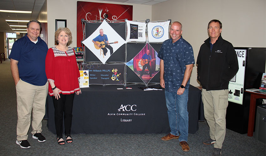 Picture of Tom Wilbeck with the library staff.