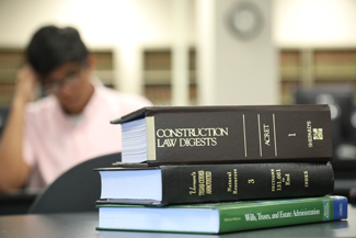 Stack of legal books sitting on desk