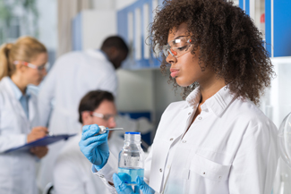 Pharmacy Technician measuring liquid medication