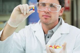 Pharmacy Technician holding a pill